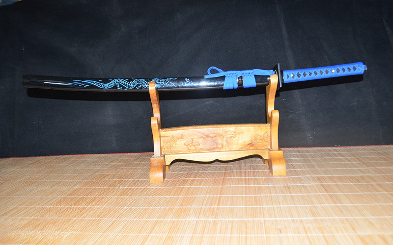 The complete Seiryu's Blade Katana, fully sheathed in its gloss-black dragon motif saya, resting on a display stand.
