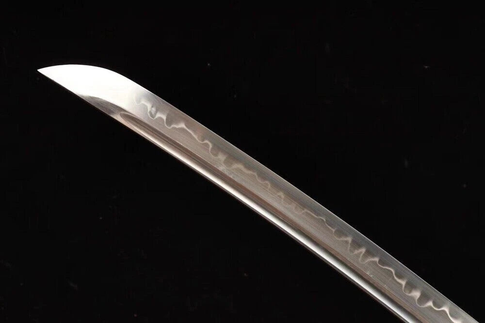 A detailed view of the T10 high-carbon steel blade, highlighting the authentic clay-tempered hamon line.