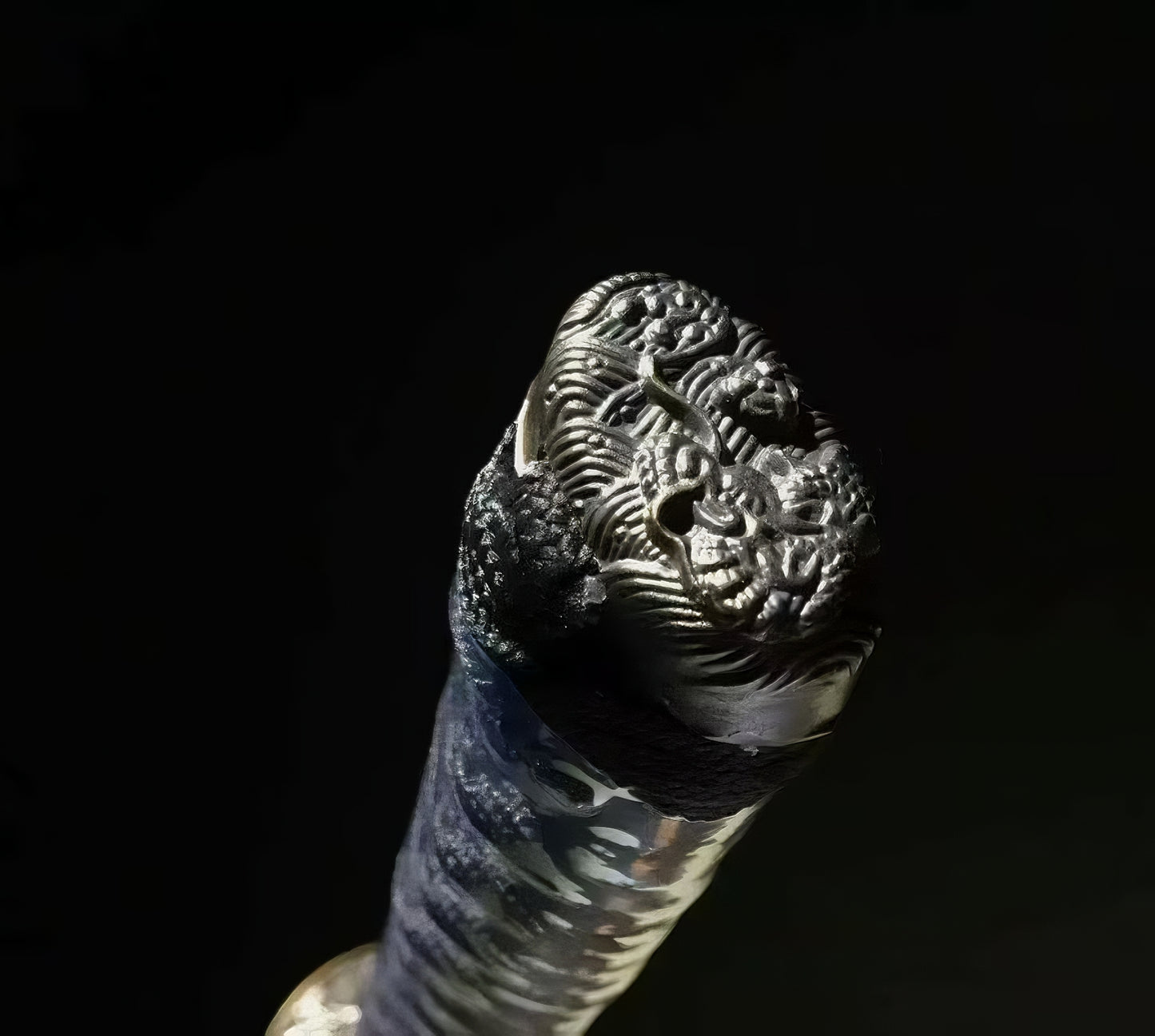 A macro shot of the kashira (pommel) of the Ryū Tsuchime Katana, featuring the intricately detailed copper dragon (Ryū) theme.