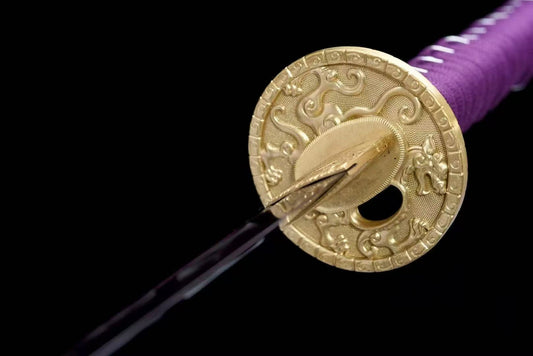 A close-up of the ornate copper tsuba (guard) of the Amethyst Flame Katana, featuring a dragon theme.