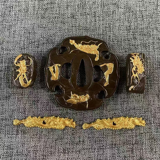 Full Koshirae set featuring gilded Shishi (guardian lions) on a dark patinated brass Tsuba, Fuchi, Kashira, and a pair of solid
