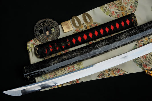 A flat-lay of the Crimson Tide Katana, showcasing the T10 steel blade, red rayskin tsuka, and disassembled brass "Great Wave" fittings.
