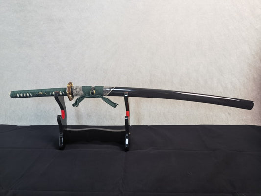 The complete Jade Serpent Katana, sheathed in its gloss-black saya featuring a half-wrap of white rayskin.