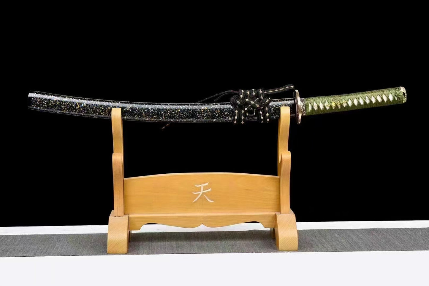 The complete Celestial Eagle Katana, sheathed in its "Starry Sky" blue and gold flake lacquer saya, on a stand.