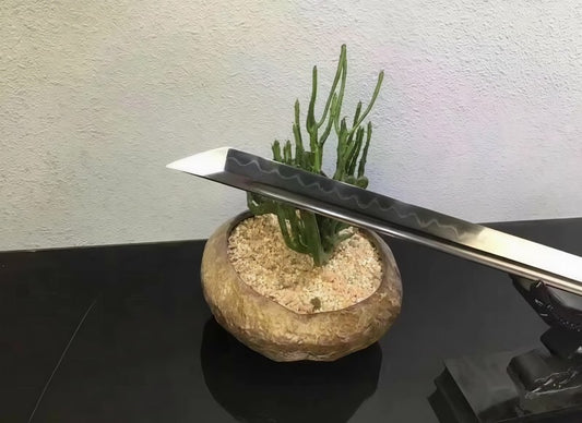 A close-up of the sharp, straight kissaki tip on the T10 steel blade of the Rosewood Ninja Sword.