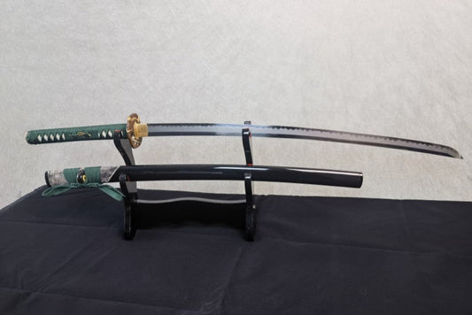The Jade Serpent Katana with its T10 steel blade and serpent-themed brass fittings, on a display stand.