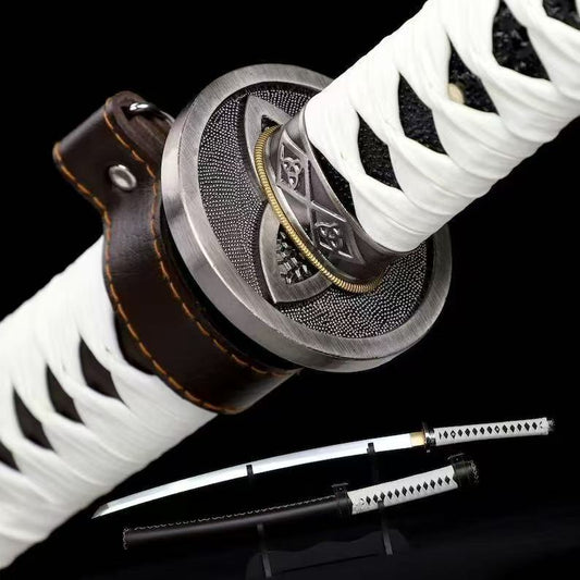 A close-up of the iconic triple-crescent tsuba guard and white leather ito wrap of Michonne's katana.