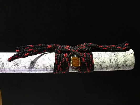 A close-up of the unique hardwood saya, showing its white marble-pattern lacquer finish and tied sageo.