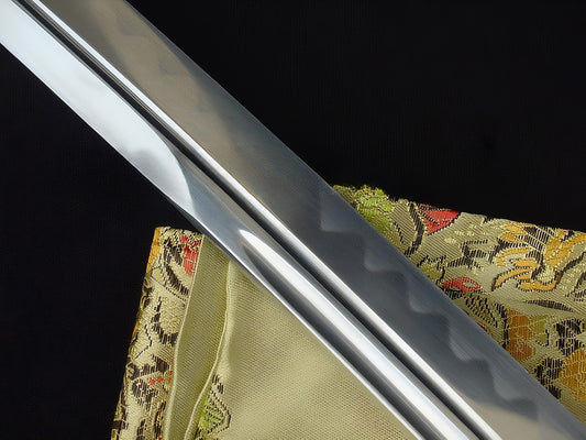 A detailed shot of the hand-polished 1095 high-carbon steel blade of The Sage's Journey Katana.