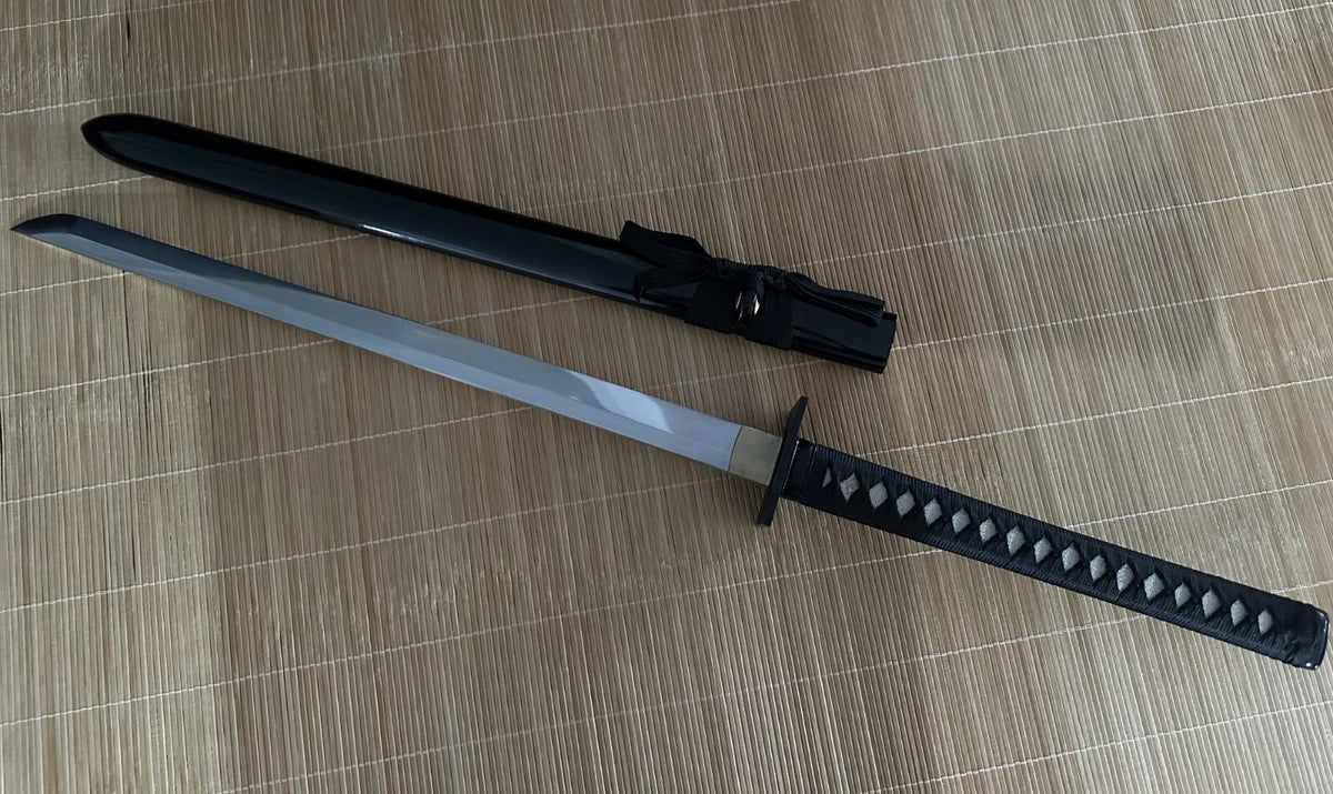A full view of the unsheathed Obsidian Gale Ninja Sword next to its gloss-black hardwood saya.