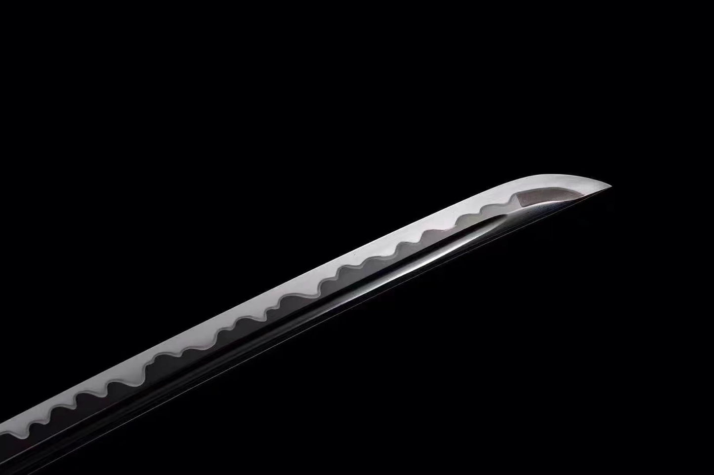 A close-up of the T10 steel blade, clearly showing the authentic and active Aesthetic hamon line.