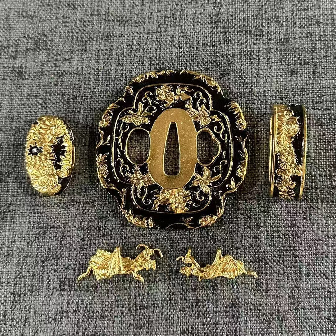 Complete Koshirae set featuring gilded Kōmori (Bat) Menuki and floral vines on a gloss black brass Tsuba, Fuchi, and Kashira.