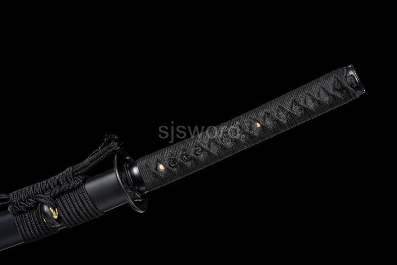 A full view of the tsuka handle, wrapped in traditional black silk ito over genuine black rayskin.