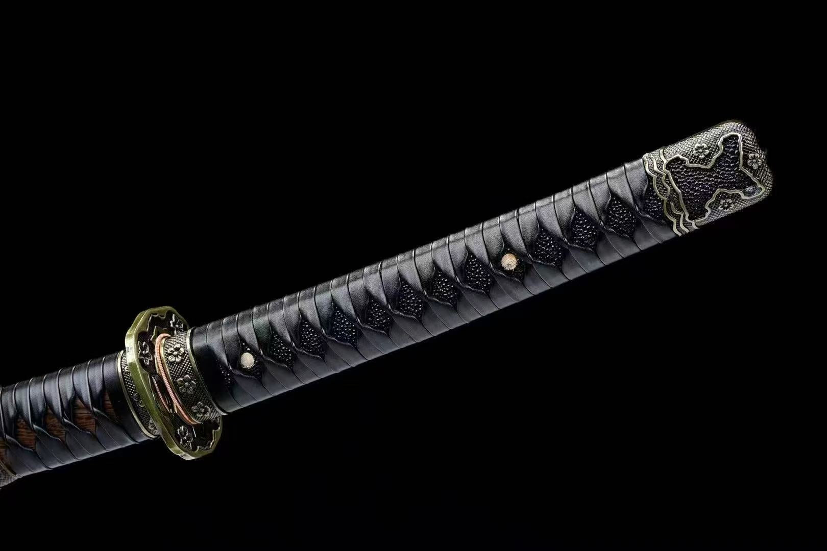 A detailed view of the Bridlewood Tachi's handle, featuring the black silk ito wrap over black genuine rayskin.