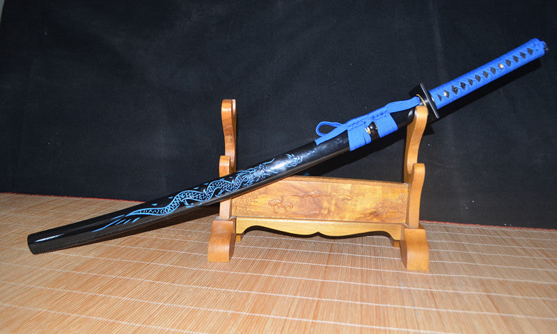 The sheathed Seiryu's Blade Katana resting at an angle on a display stand, highlighting the gloss-black dragon motif saya.