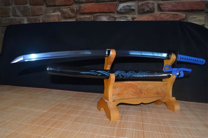 The Seiryu's Blade Katana unsheathed on a display stand, showing the blue folded steel blade and its blue dragon saya.