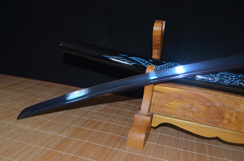 The unsheathed Seiryu's Blade Katana resting on its stand, displaying the full blue folded steel blade with bo-hi.