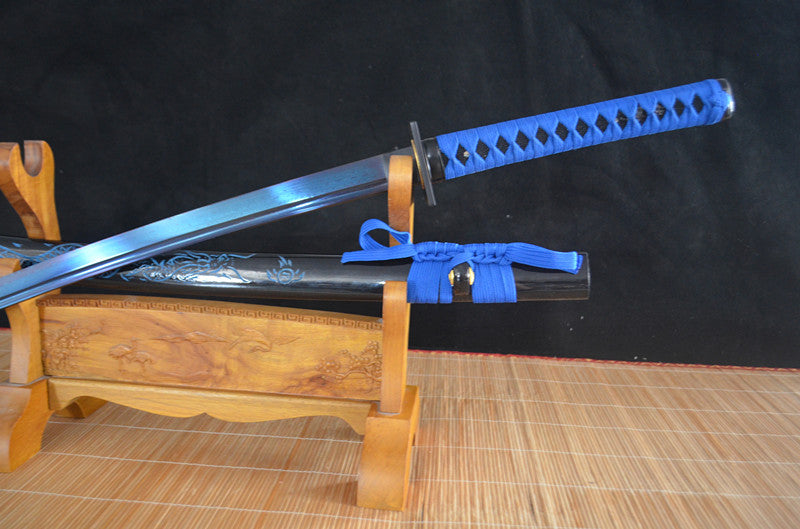 A close-up of the tsuka handle, featuring the vibrant blue silk ito wrap over genuine black rayskin.