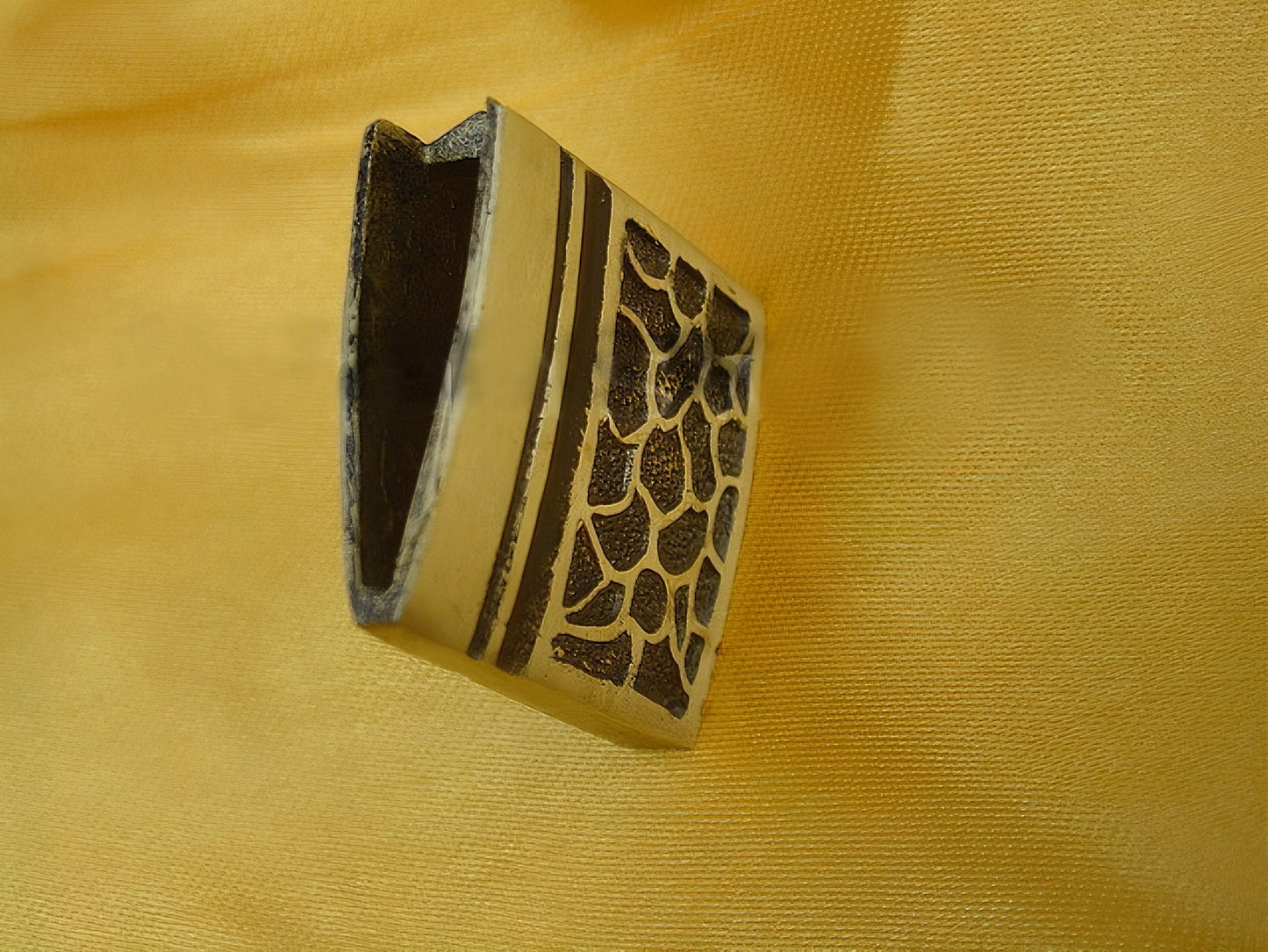 A detailed close-up of the brass habaki (blade collar) with its distinct textured pattern.