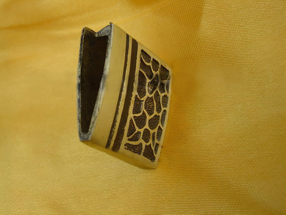 A detailed close-up of the brass habaki (blade collar) with its distinct textured pattern.