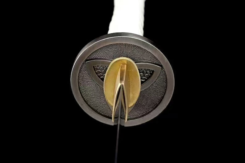 A view looking down the triple-crescent tsuba towards the brass habaki and the 1095 steel blade.