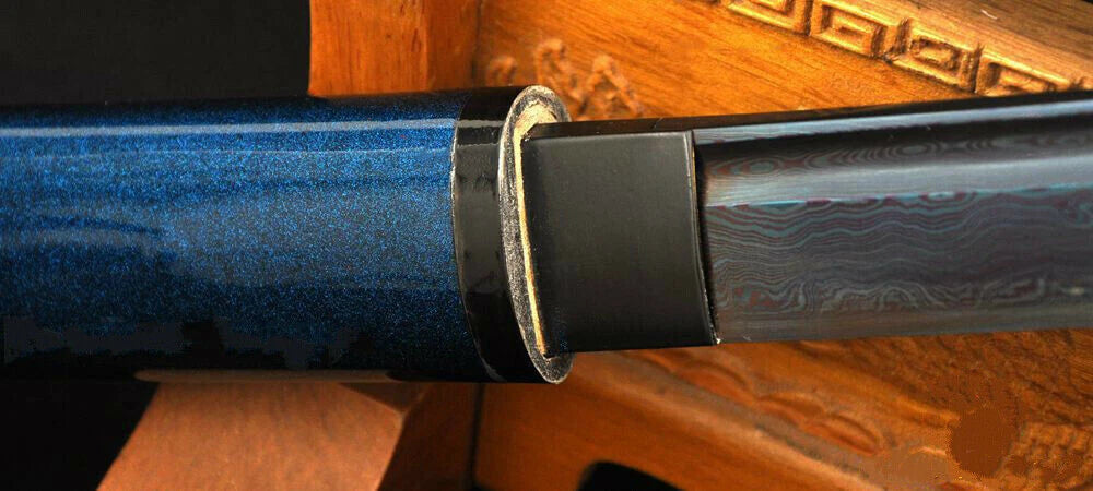 A close-up of the koiguchi (mouth of the scabbard), reinforced with genuine buffalo horn.