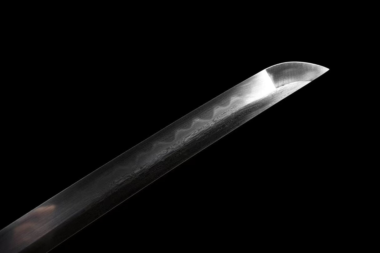 A view of the hand-forged blade, highlighting its sori (curvature) and the active clay-tempered hamon line.