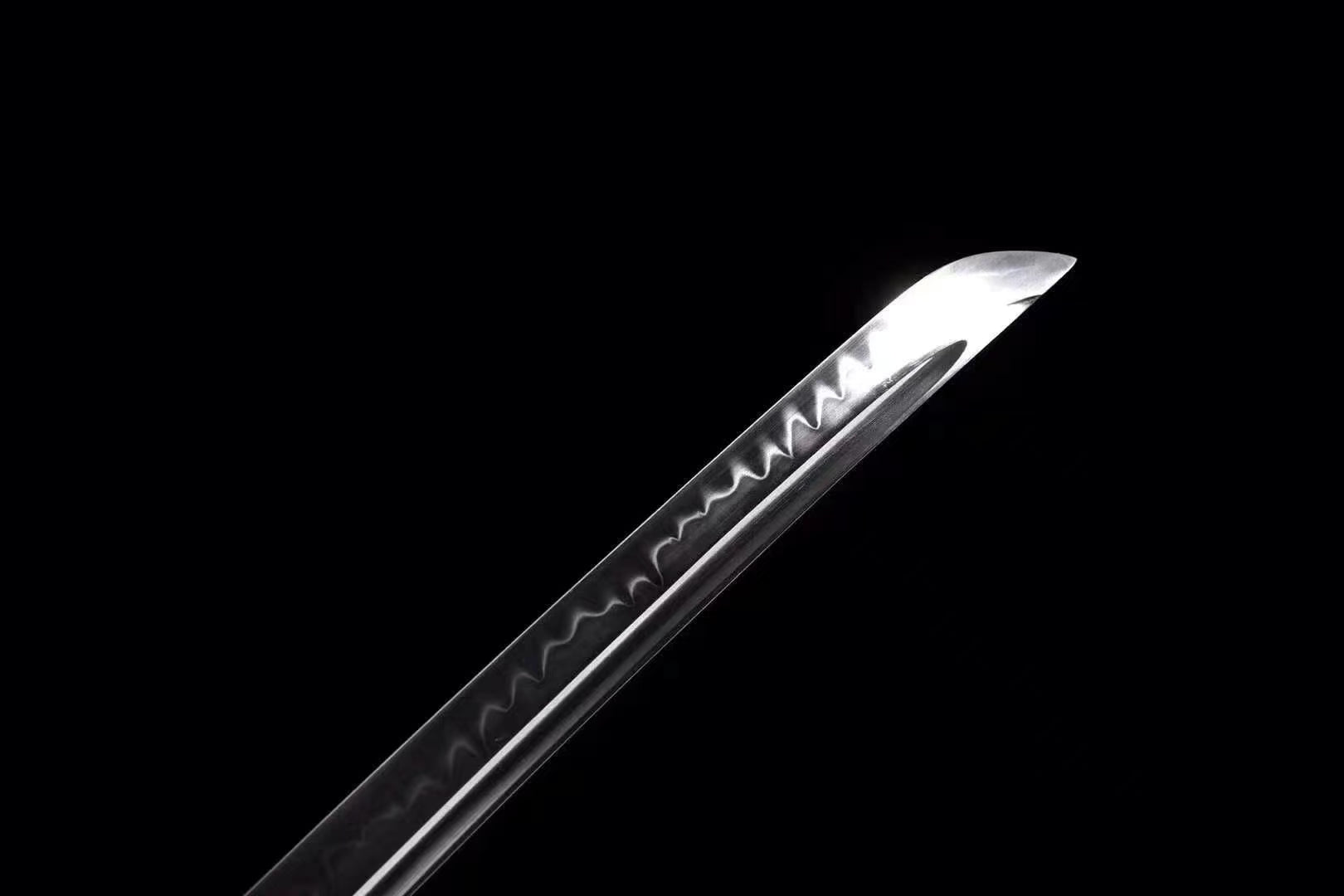 A detailed close-up of the T10 steel blade, clearly showing the authentic and active clay-tempered hamon line.