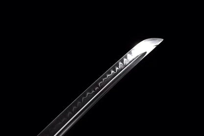 A detailed close-up of the T10 steel blade, clearly showing the authentic and active clay-tempered hamon line.