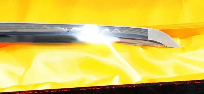A detailed shot of the T10 steel blade, clearly showing the authentic and active clay-tempered hamon.