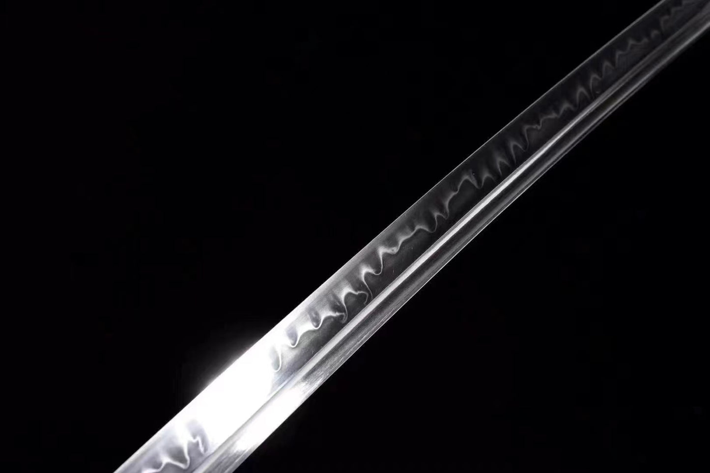 An alternate, bright close-up of the blade, highlighting the wave pattern of the clay-tempered hamon.
