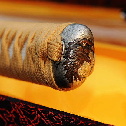 A detailed macro shot of the Taka's Sky Katana's kashira (pommel), showcasing the intricately carved copper "Taka" (Eagle) head.