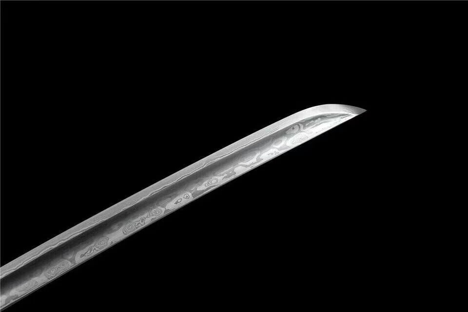 A macro shot of the blade, showcasing the distinct layers and grain pattern (hada) of the 1060 folded steel.