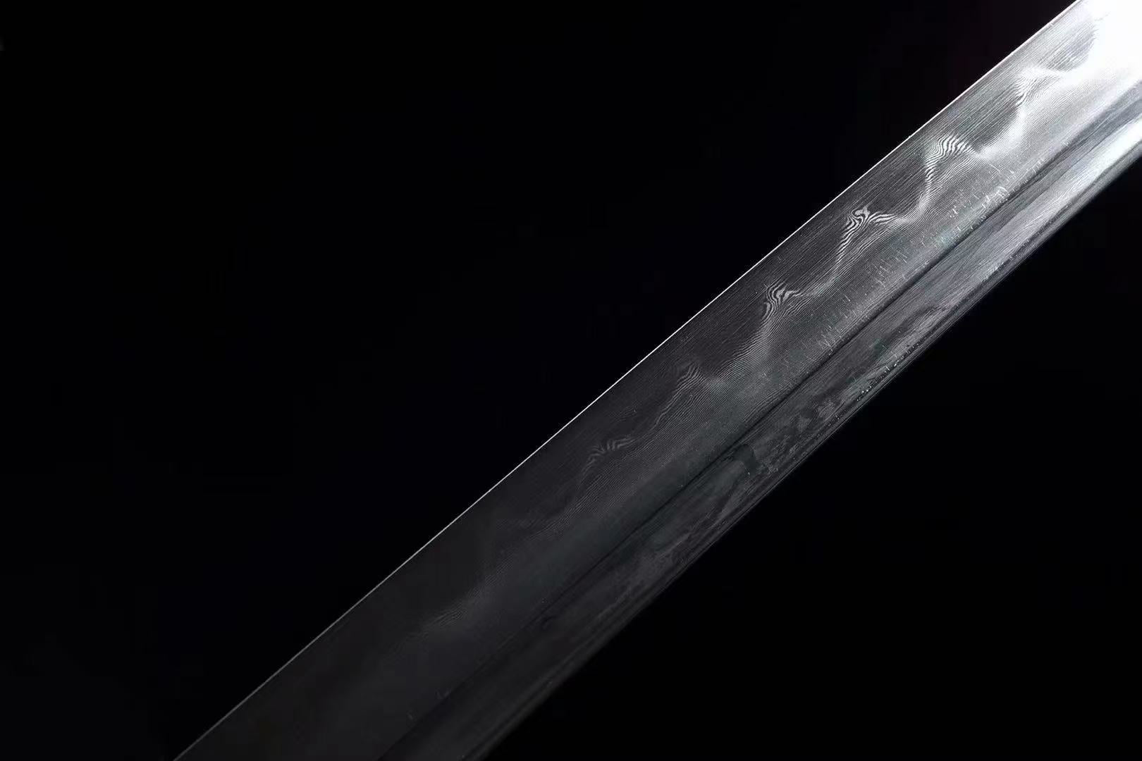 A macro shot of the Bridlewood Tachi's blade, revealing the folded steel pattern (hada) and clay-tempered hamon.