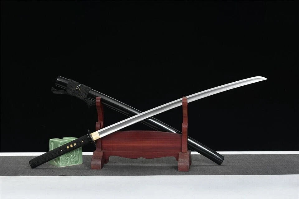 A side view of the unsheathed Winter Plum Katana on its stand, displaying the entire folded steel blade.