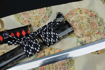 A close-up of the luxurious full-wrap polished black genuine rayskin (Same-Koshirae) saya of the Crimson Tide Katana.
