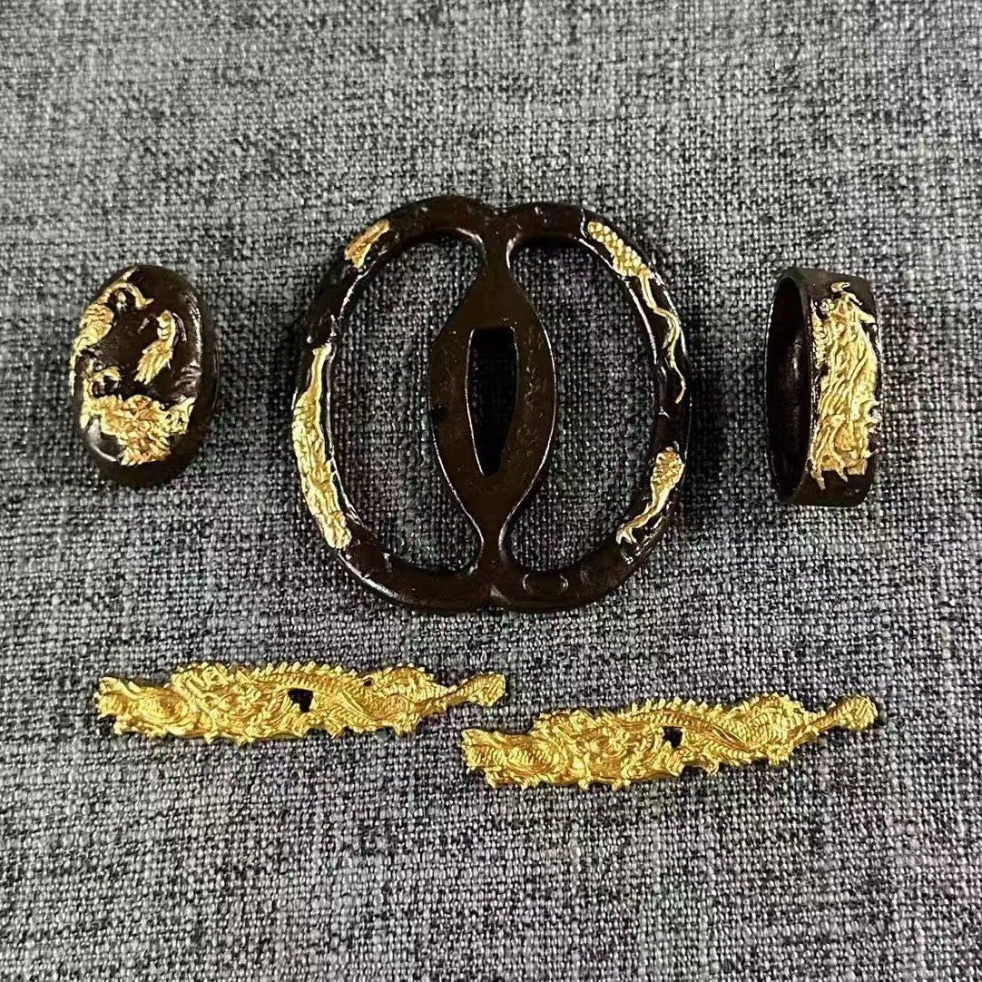 Complete Koshirae set featuring a gilded dragon motif on a blackened brass Sukashi Tsuba, with matching Fuchi, Kashira, and Menuki.