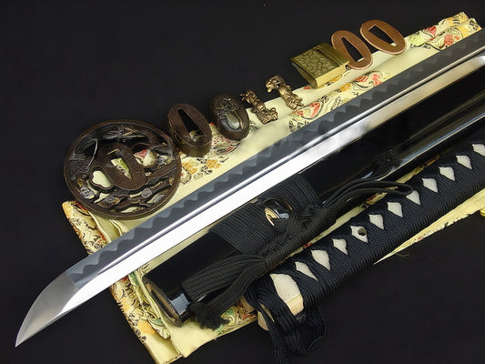 A close-up of The Sage's Journey Katana's handle and tsuba, showcasing the partially gilded and silvered brass fittings.