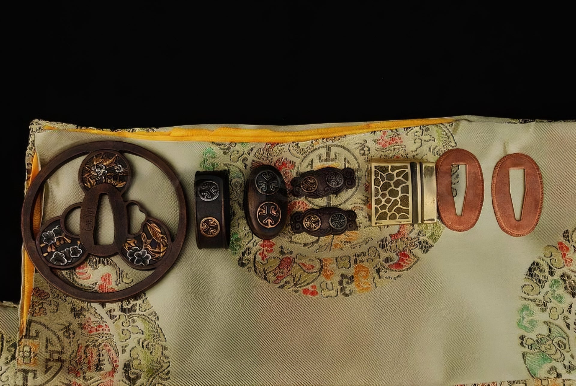 An alternate top-down view of the antique copper fittings with gilded accents, featuring the "Mitsudomoe" crest and other floral motifs.