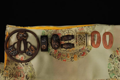 An alternate top-down view of the antique copper fittings with gilded accents, featuring the "Mitsudomoe" crest and other floral motifs.