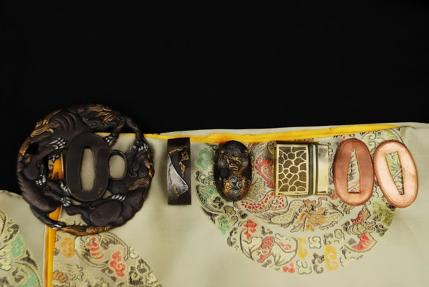 An alternate flat-lay view of the complete "Shishi" (Guardian Lion) theme koshirae set for the Sennin's Guardian Katana, including the gilded tsuba, fuchi, and kashira.