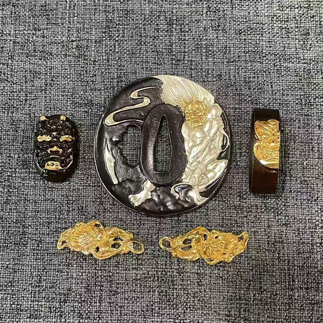 Complete Koshirae set featuring a powerful Gilded & Silvered Oni (demon) on a textured black brass Tsuba, with matching dual-tone Fuchi, Kashira, and Menuki.