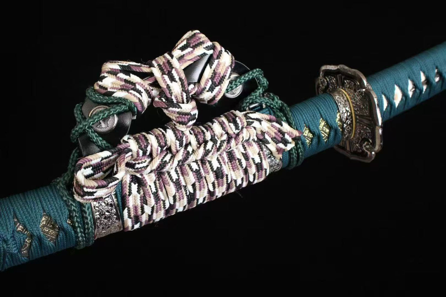 A macro shot of the intricate knot work on the verdant green silk ito wrap of the Verdant Trace Tachi.