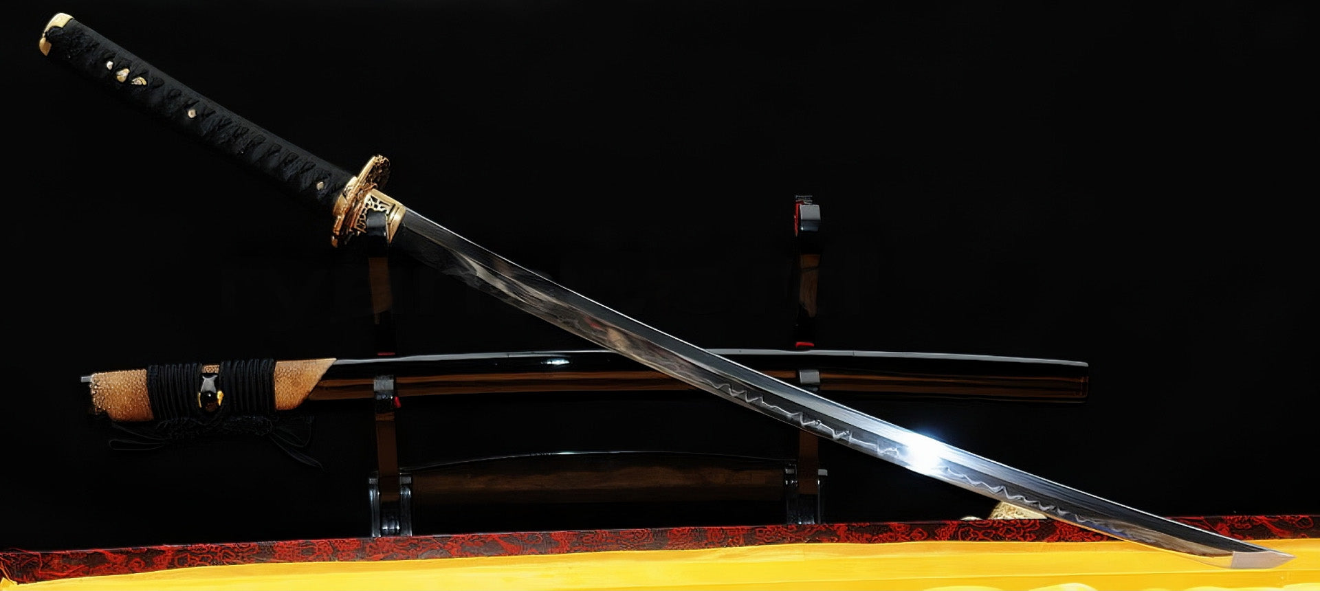 A dynamic angle of the unsheathed Golden Hawk Katana, showcasing the T10 clay-tempered blade's Hadori polish and the brass hawk fittings.