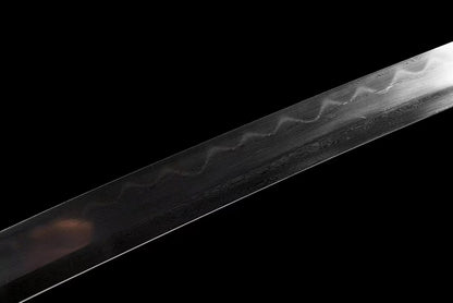 A close-up of the Honsanmai blade, showcasing the folded steel pattern (hada) and the real clay-tempered hamon.