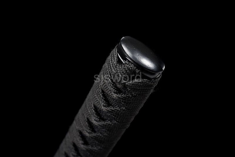A close-up of the alloy kashira (pommel) at the end of the tsuka handle.