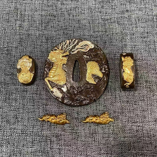 Complete Koshirae set featuring a gilded and silvered Kirin (celestial beast) on a textured black brass Tsuba, with matching Fuchi, Kashira, and Menuki.