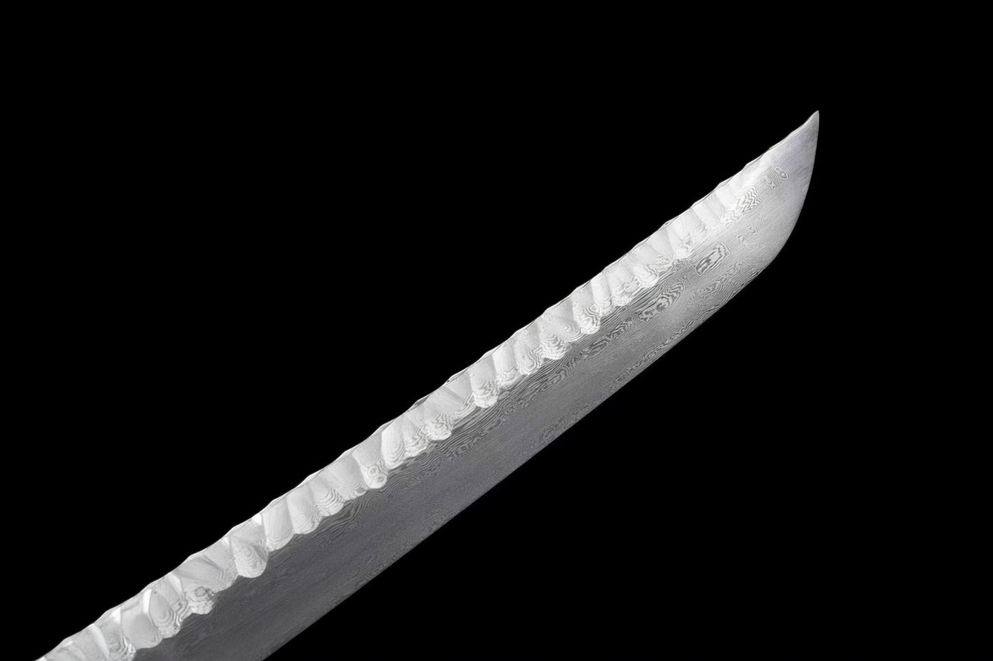 A close-up of the chu-kissaki (tip) of the Ryū Tsuchime Katana, highlighting the Tsuchime hammered spine and the folded steel blade.