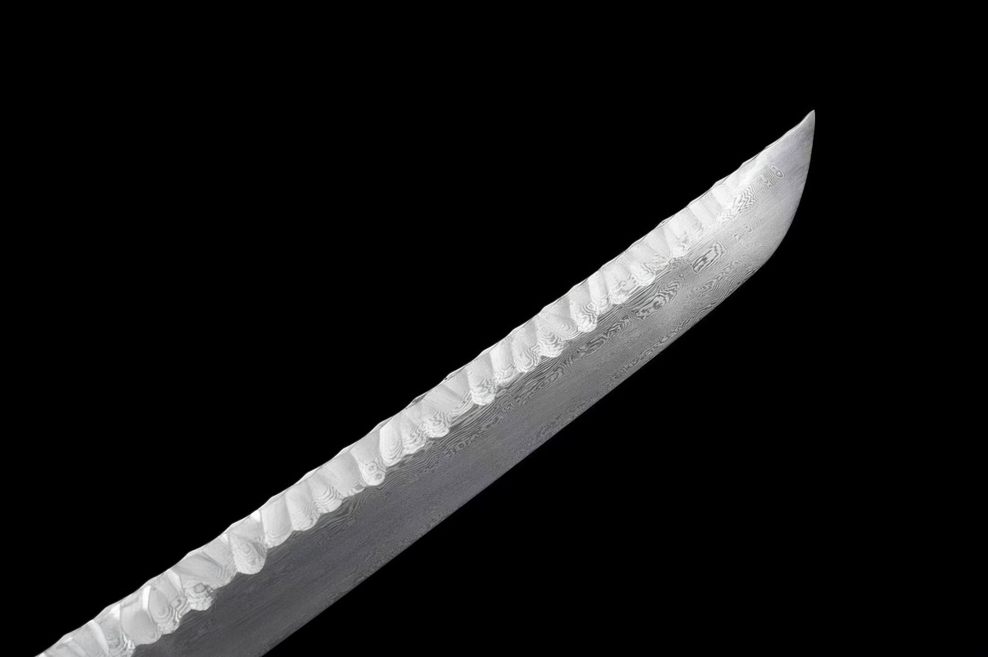 A close-up of the chu-kissaki (tip) of the Ryū Tsuchime Katana, highlighting the Tsuchime hammered spine and the folded steel blade.