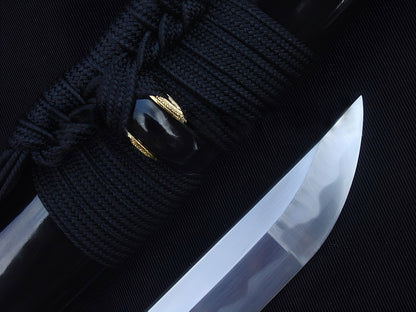 A close-up of the Kiku's Reflection Katana, showing the mirror-polished 1095 steel kissaki (tip) next to the high-gloss black saya.